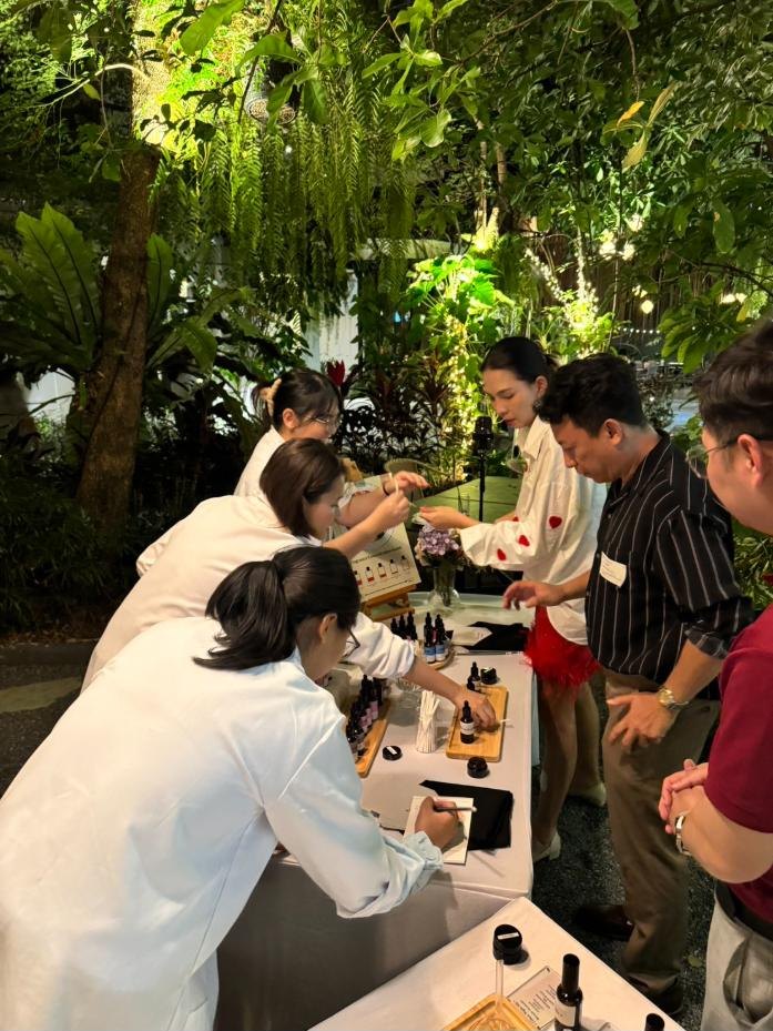 Company team blending perfume at an outdoor event